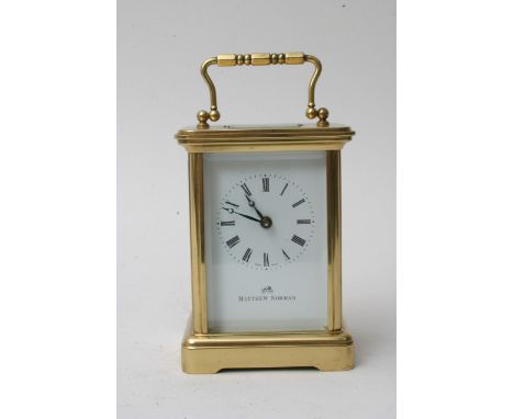 A Matthew Norman brass carriage clock with Roman numerals and enamel dial, with fitted case and paperwork