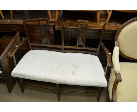 A Victorian walnut open arm chair, with carved back and upholstered seat on turned legs and a small edwardian sofa