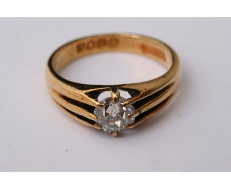 An 18ct yellow gold ring set with a single diamond, approximately size K