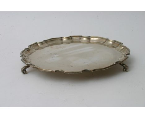 A silver scalloped card tray on scrolled feet, Birmingham Hallmarks (673 grams)