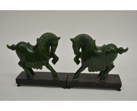A Pair of Chinease Carved Jade horses on black lacquer bases. 10cm heigh. 
