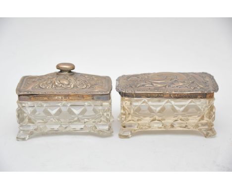 Two matching silver topped and cut glass trinket boxes with Birmingham hallmarks.