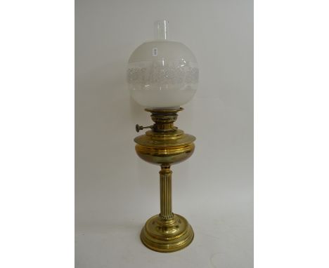 A brass oil lamp with clear and frosted glass shade, approx 178cm.