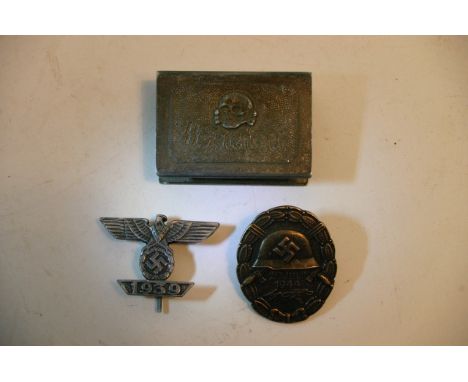 A German Nazi 1939 stick pin, a German badge and match holder (3).