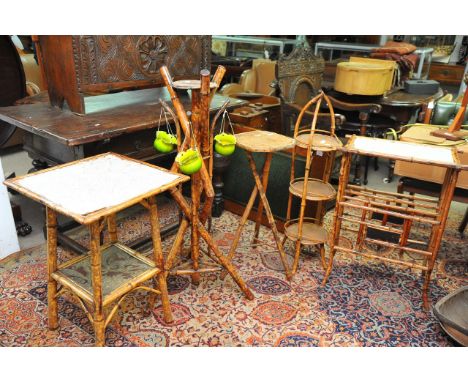 A collection of oriental style bamboo and cane plant stands and occasional tables