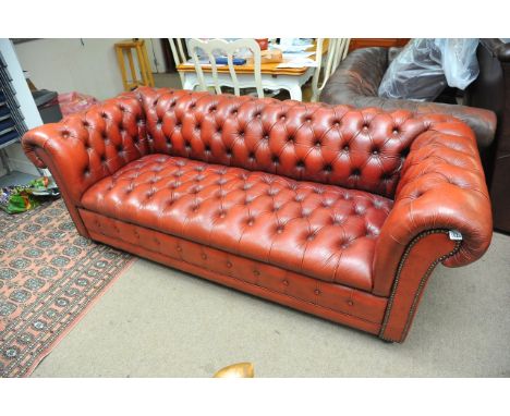 A red leather Chesterfield sofa, approx 188cm x 85cm x 71cm.