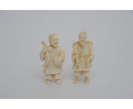 Two Japanese late 19th century Ivory carvings in the form elders holding a fish and smoking pipe (2)