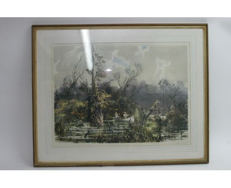 A large framed print depicting lakeview with figures fishing
