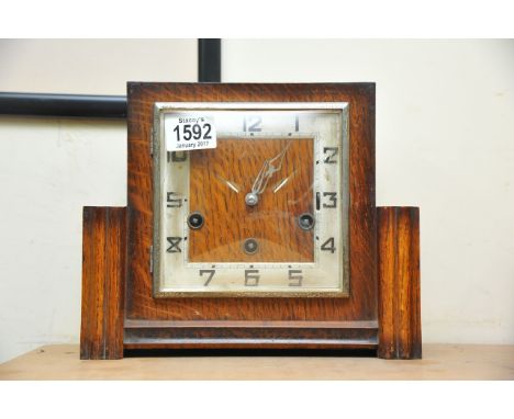 An Oak cased Deco style Westminster chime Mantel clock the square dial with Arabic numerals