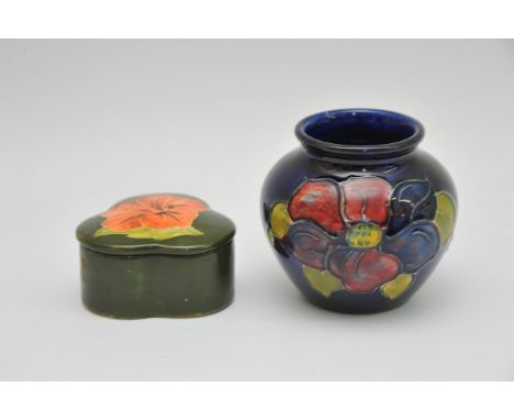 A small Moorcroft 'Clematis' pattern vase and a shamrock shaped 'Hibiscus' pattern trinket box. Approximately, 8cm high and 7