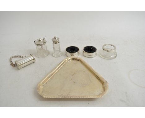 A collection of small silver items comprising a condiment set on tray, two napkin rings and an engraved cork holder