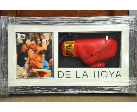 A framed boxing montage containing a signed Oscar De La Hoya boxing glove and print with certificate of authenticity, approx 