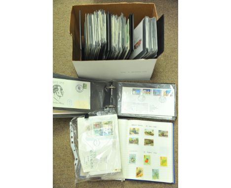 A box containing GB first day covers and an album of used stamps.