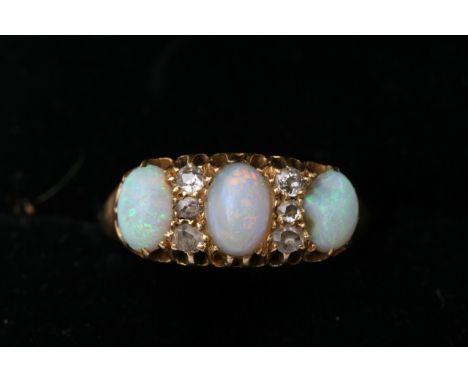 A Vintage 18ct gold ring set with three opals ring size K 