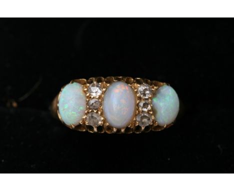 A Vintage 18ct gold ring set with three opals ring size K 