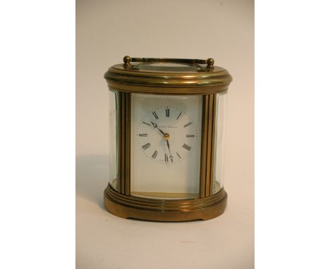 A fine Mathew Norman four glass carriage clock of oval shape, with key