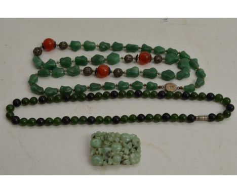 A vintage Jade necklace with silver mounts and applied enamel decoration, one other jade bead necklace and a jade brooch. (3)