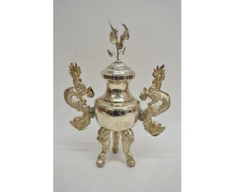 A large Chinese silver censer  on tripod feet with handles formed as dragons, the lid surmounted with a fancy bird, inscribed