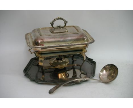 A silver plated entree dish, a hot plate, tray and a large ladle,