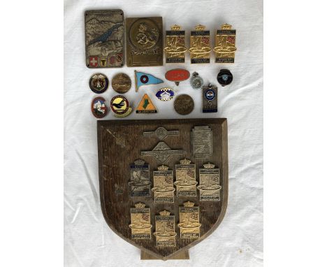 A selection of assorted Royal Automobile Club Rally of Great Britain badges mounted on a shield, mostly late 1950s plus a gro