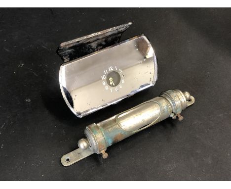 An interior rear view mirror with integral clock, on bracket plus a dash mounted nickel plated reading light. 