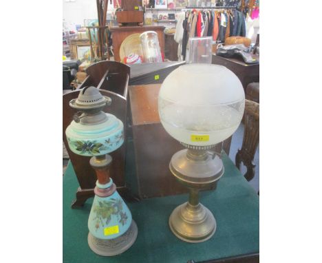 A Victorian opaline glass and gilt metal oil lamp with floral decoration, and a brass oil lamp with frosted and etched globe 