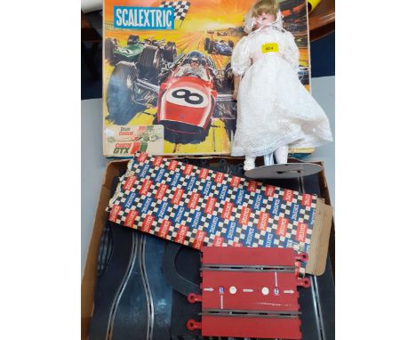 A vintage Scalextric Sports 31 set comprised of track only together with a reproduction bisque faced doll on standLocation: A