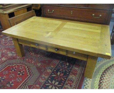 A modern light oak coffee table having two inset drawers and on block shaped legs, 45cm h x 140cm w, together with a matching