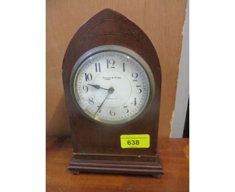 A Mappin and Webb retailed Edwardian mantel clock in inlaid mahogany arched case, on four gilt metal cushioned ball feet, whi