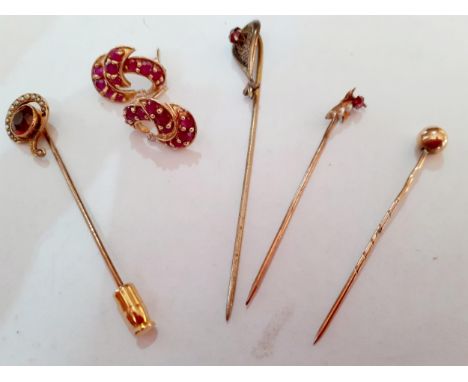 A pair of yellow metal and ruby earrings, tests as gold together with a yellow metal and ruby stick pin, tests as gold, a yel