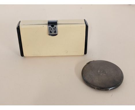 A silver compact with engine turned decoration and an Art Deco style metal compactLocation: 