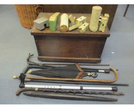 A mixed lot to include a parasol, walking sticks including one with a handle in the shape of a dog's head, a twin handled tru