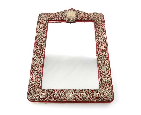 An Edwardian silver-mounted mirror, by Henry Matthews, Chester 1905,rectangular form, chased and pierced foliate scroll decor