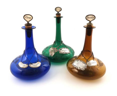 Three 19th century coloured glass decanters,tapering circular ship decanter form, engraved with grapes, thistles, roses and s