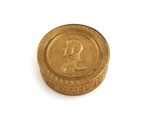 A 19th century gilt-metal commemorative Wellington snuff box,circular form, the pull-off cover with a portrait of Wellington 