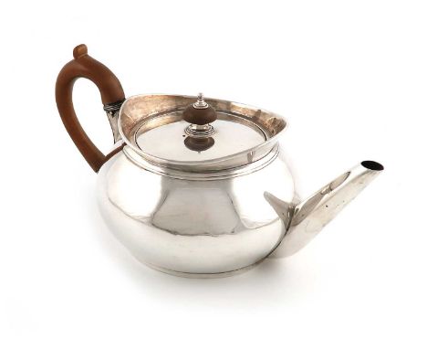 A George III provincial silver teapot,by Hampston, Prince &amp; Cattles, York 1801,plain circular cape form, wooden scroll ha