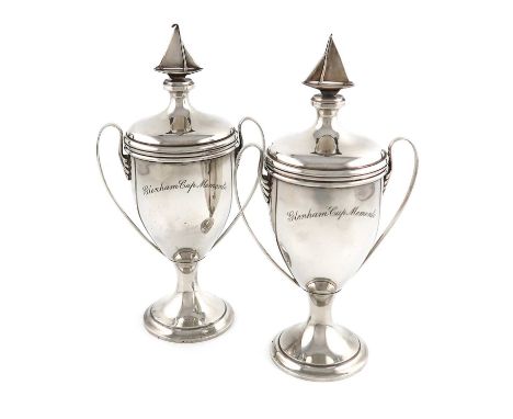 A pair of silver yachting trophy cups,by Edward Dimes, London 1935,vase form, plain scroll handles, pull-off cover with a yac