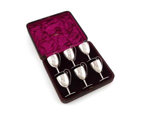 A cased late-Victorian set of six silver tot cups, by Roskell, Roskell & Hunt, London 1887,urn-shaped bowls, gilt interiors, 