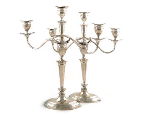 A pair of modern silver three-light candelabra,by Mappin and Webb, Sheffield 1959,tapering oval columns, plain scroll branche