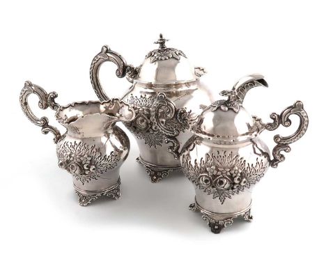 A three-piece Chinese silver tea set,marked to the underside with Chinese characters,baluster form, foliate decoration, leaf-
