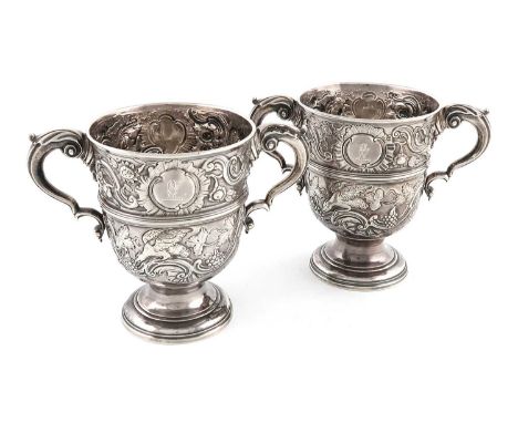 A pair of mid-18th century Irish silver two-handled cups,marks partially lost in decoration, possible maker's mark M or W, ci