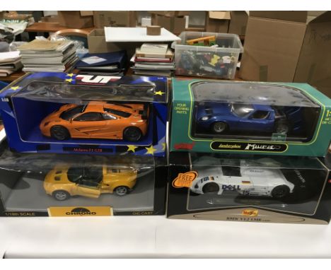 Four 1/18 scale diecast racing cars: Chrono Lotus Elise 1997 'Norfolk Mustard'; UT Models Mclaren F1 GTR; Maisto BMW V12 LMR 