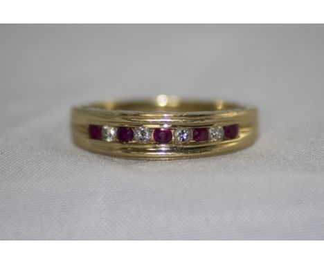 14ct Gold Ruby and Diamond Channel Set Ring. Marked 14 kt. 