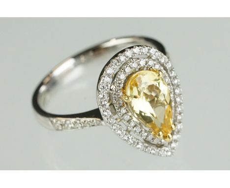 Yellow beryl and diamond 18ct white and yellow gold set halo ring, the pear-shaped yellow beryl measuring approx 10mm x 6mm, 