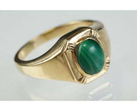 Malachite 9ct yellow gold ring, oval cabochon cut malachite measuring approx 8.5mm x 7mm, rubover set, tapered shoulders, rin