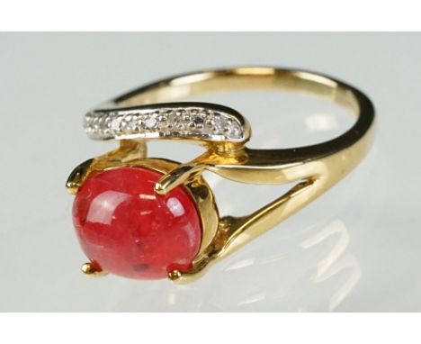 Red opal and diamond 9ct yellow and white gold set ring, the oval cabochon cut opal measuring approx 10mm x 8mm, claw set, el