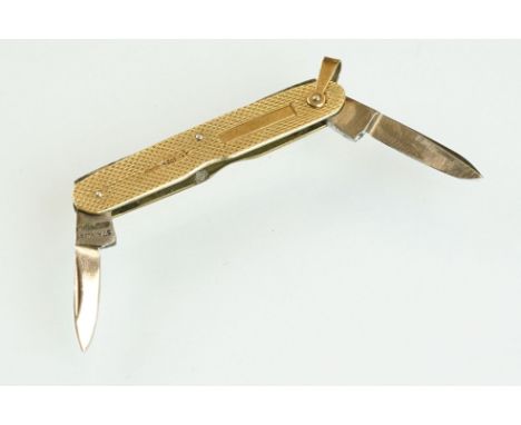 9ct yellow gold cased double folding penknife, engine turned decoration, length when both extended approx 10cm, hallmarked Bi