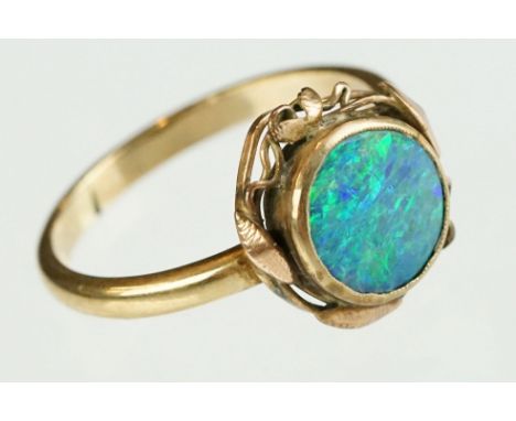 Opal triplet unmarked yellow gold ring, the round opal triplet head diameter approx 8.5, rubover set, stylised openwork lead 