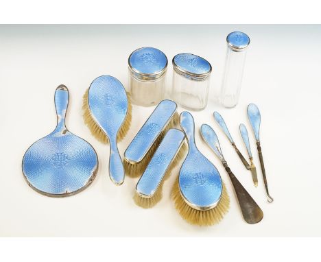 George V Silver &amp; blue guilloche enamel eight-piece vanity set, comprising a hand mirror (24.5cm long), two clothes brush