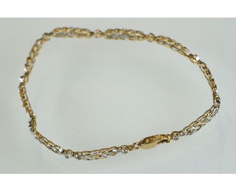 Diamond 9ct yellow and white gold bracelet, nine Celtic-style knot design panels, ten small rose cut diamond spacers, rubover